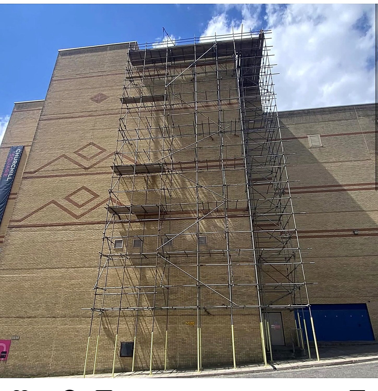 Independent scaffold up the full height of a commercial brick building in London