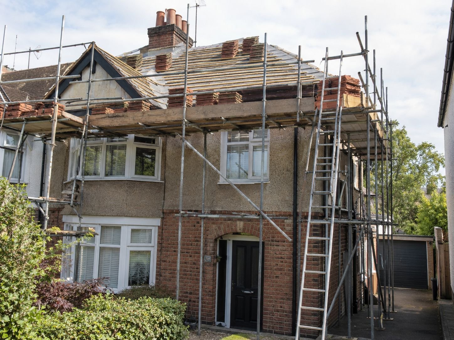 Scaffolding around a suburban semi-detached house during a re-roof
